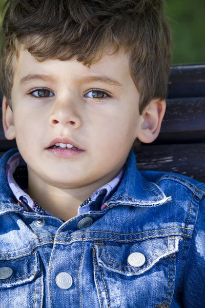 Blonde boy in sunny park looking at camera — Stock Photo, Image