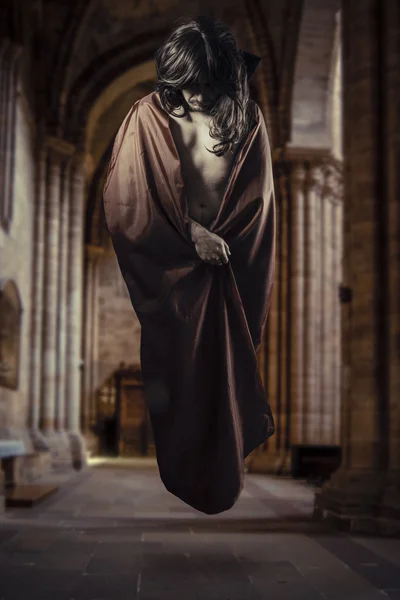 Magician levitating inside a Gothic cathedral — Stock Photo, Image