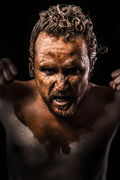 Homme en colère, Guerrier jeune couvert de boue — Photo