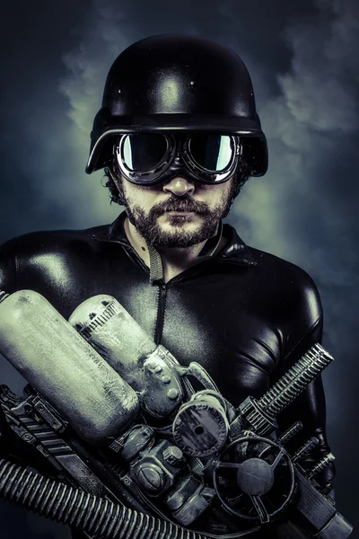 Man of the future with huge laser cannon shotgun over cloudscape — Stock Photo, Image