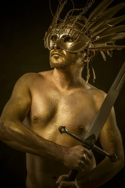 Combative, warrior or ancient god with golden mask and sword gre — Stock Photo, Image