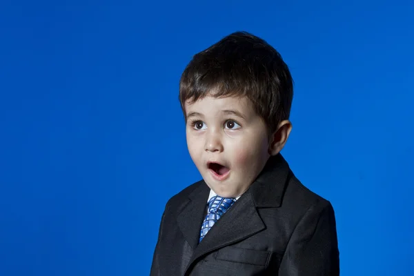 Businessman, cute little boy portrait over blue chroma backgroun — Stock Photo, Image