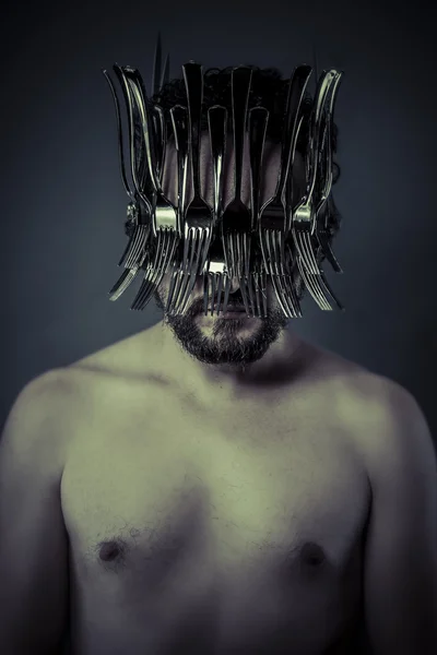 Man in helmet made from forks — Stock Photo, Image