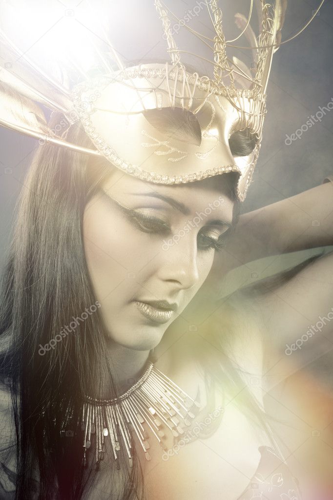 Woman with fashioned golden mask