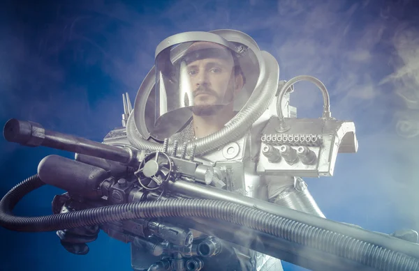 Astronaut with huge weapon. — Stock Photo, Image
