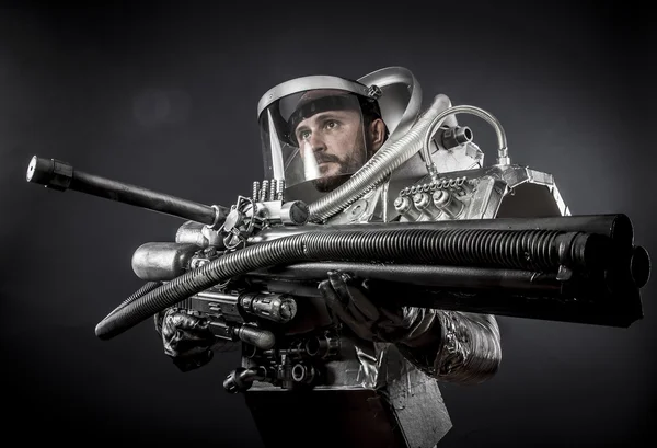 Astronaut with huge weapon. — Stock Photo, Image