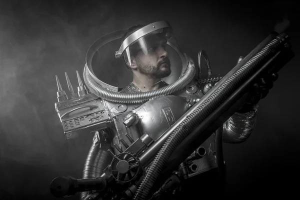 Astronaut with huge weapon. — Stock Photo, Image