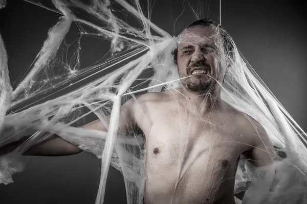 Man tangled in spider web — ストック写真