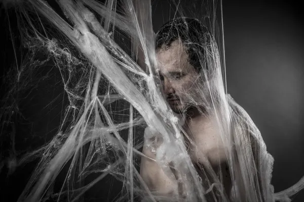 Man tangled in spider web — Stockfoto