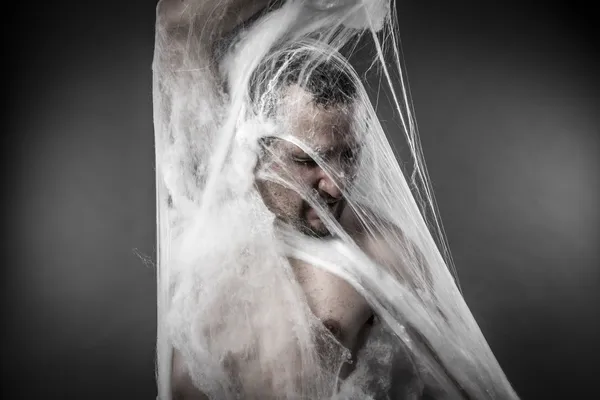 Man tangled in spider web — Stock fotografie