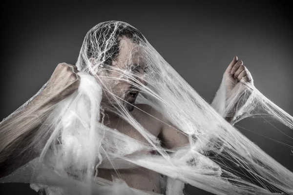 Man tangled in spider web — ストック写真