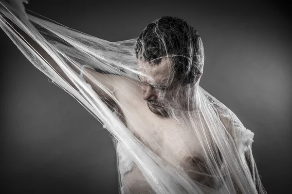 Man tangled in spider web — Zdjęcie stockowe