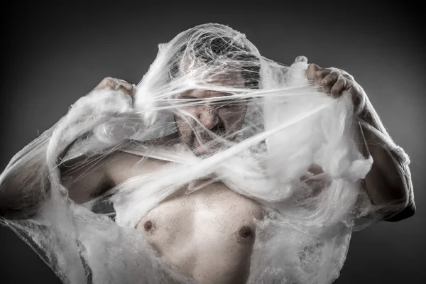 Man tangled in spider web — Zdjęcie stockowe
