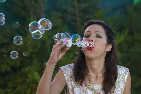 Woman blowing bubbles. — Stock Photo, Image