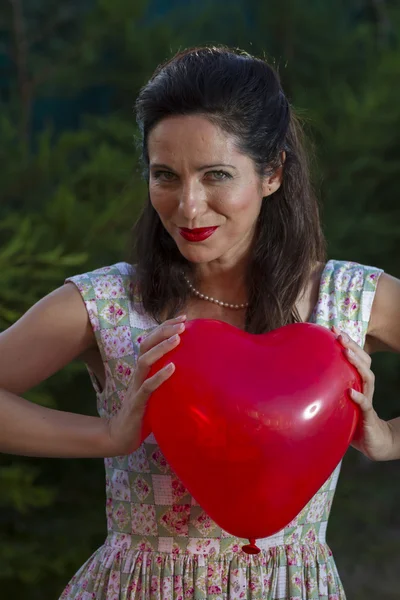 Woman with a red heart — Stock Photo, Image