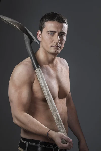 Male worker holding a shovel — Stock Photo, Image