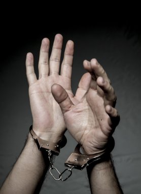 hands with handcuffs. Prison riot concept.  clipart