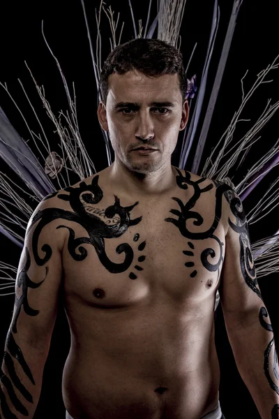 Young man with tribe tattoo — Stock Photo, Image