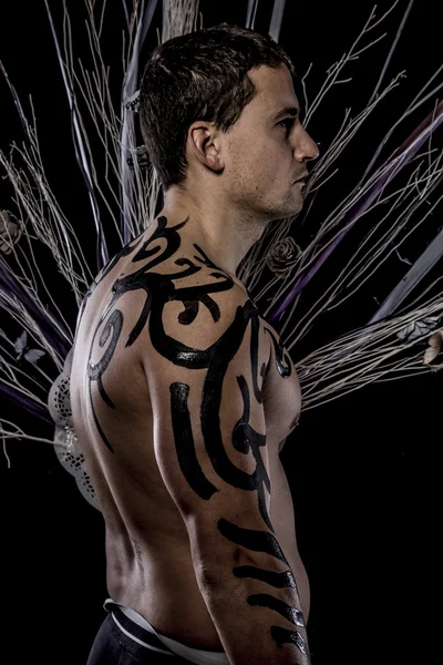 Young man with tribe tattoo — Stock Photo, Image