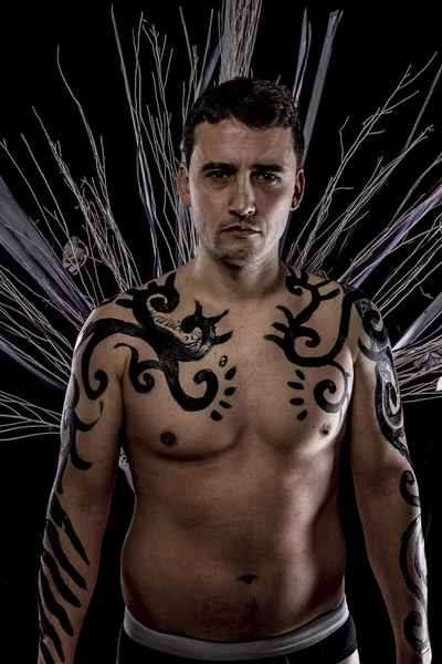 Young man with tribe tattoo — Stock Photo, Image