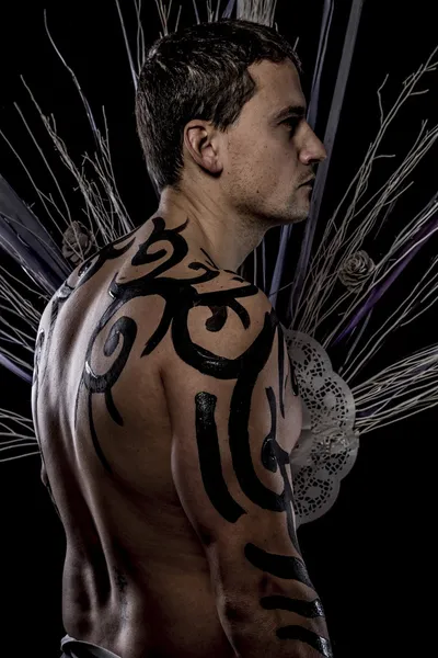 Young man with tribe tattoo — Stock Photo, Image