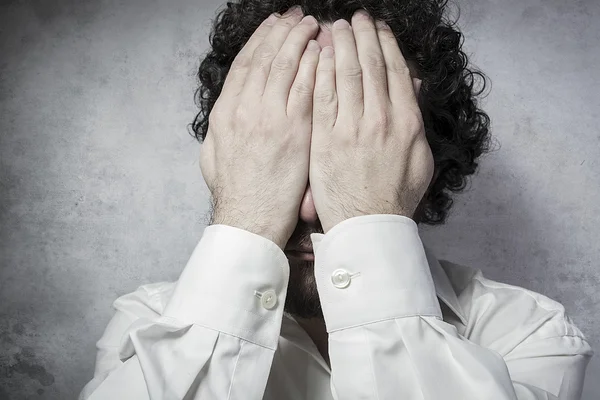 Businessman covering his eyes — Stock Photo, Image