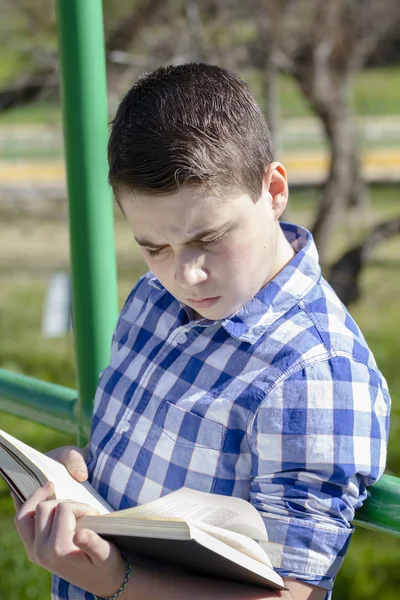 Boy lying beside a wagon wheel — Stock Photo, Image