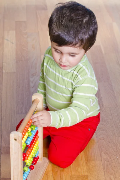 Boy playing with plastic blocks — Stock Photo, Image