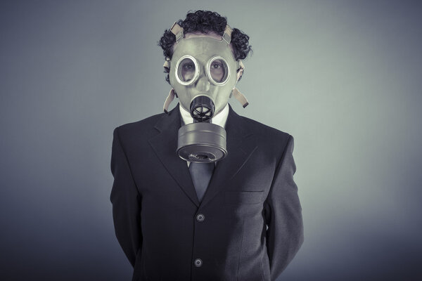 Business man wearing a gask mask