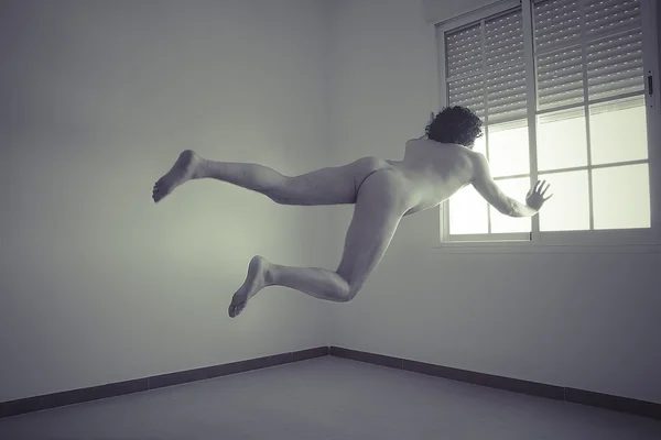 Nude man flying into a window — Stock Photo, Image