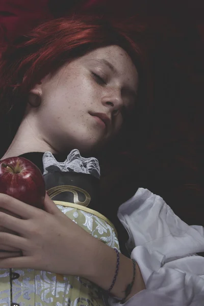 Teen with a red apple lying — Stock Photo, Image