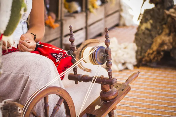 Woman spinning yarn