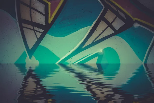 Graffiti reflection in the water — Stock Photo, Image