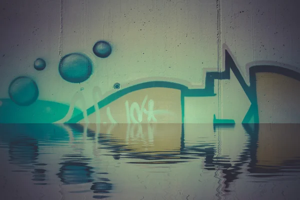 Graffiti reflection in the water — Stock Photo, Image