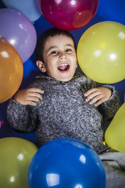 Мальчик играет с воздушными шарами — стоковое фото