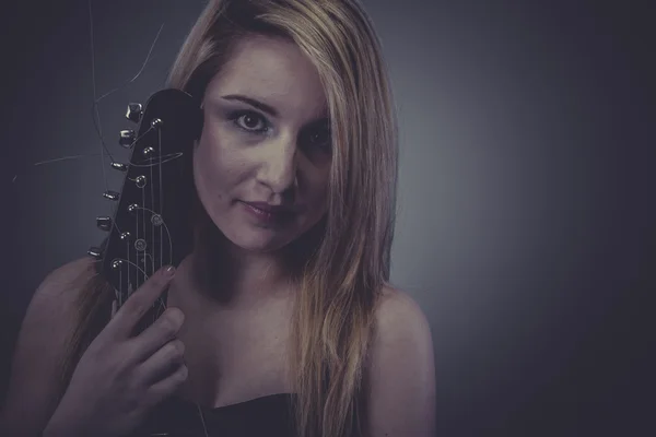 Blonde with black electric guitar — Stock Photo, Image