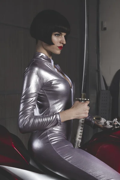 Woman in latex mounted on a motorcycle — Stock Photo, Image