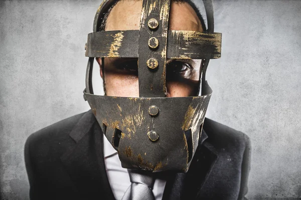 Homem de negócios perigoso com máscara de ferro — Fotografia de Stock