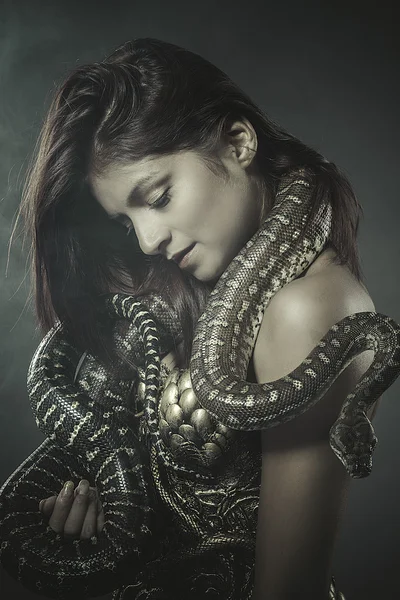 Woman in bronze corset with snake — Zdjęcie stockowe
