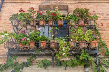 Yaz, çiçek saksıları olan eski bina cephesi. Orta İspanya 'da turizm, tipik bitki dekorasyonu
