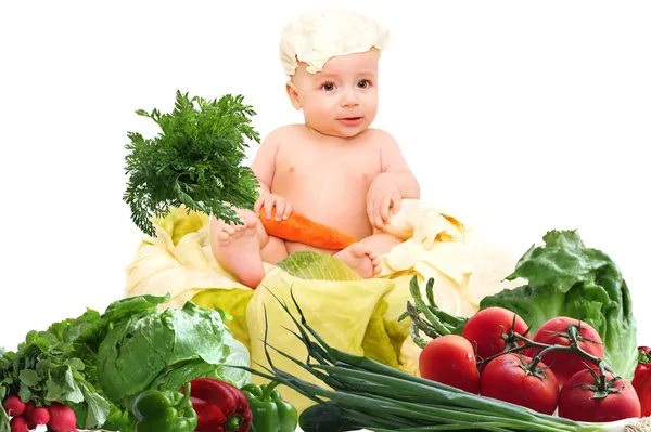 Cute baby chef with big pot and vegetables — Stock Photo, Image