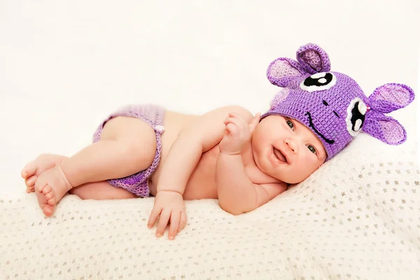 A newborn baby in purple knitted cap — Stock Photo, Image