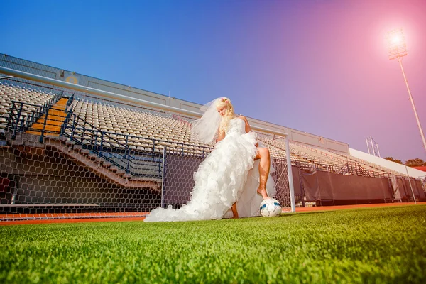 Beautiful bride on the football field — Stock Photo, Image