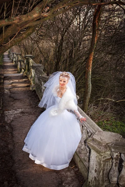 Beautiful bride with elegant white wedding dress with hand to head — Stock Photo, Image