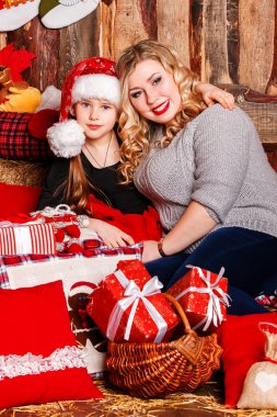 genç anne ve kızı bir şöminenin üstünde Noel tarafından