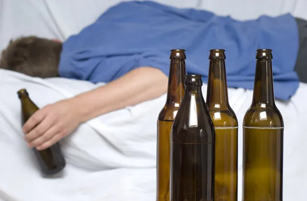 Man passed out with a beer bottle in his hand — Stok fotoğraf