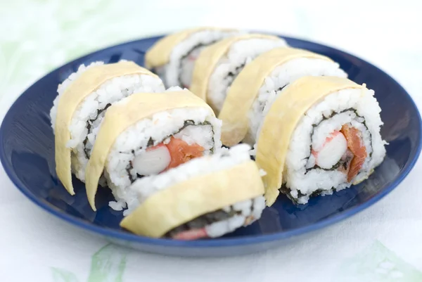 Crab and salmon sushi with a layer of egg — Stock Photo, Image