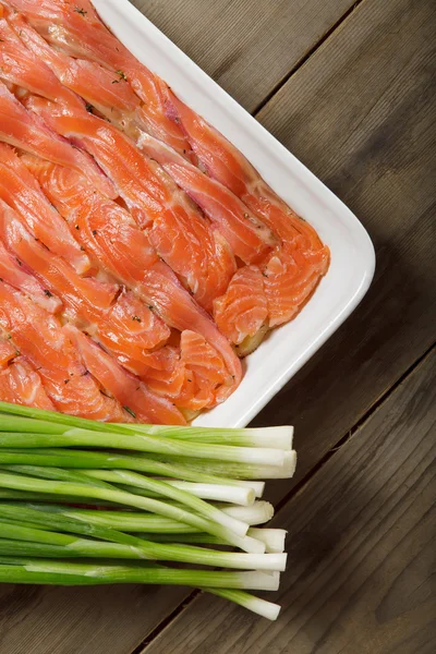 The dish for baking with thin slices of salmon — Stock Photo, Image