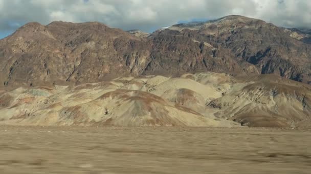 Ölüm Vadisi 'ne yolculuk, Artists Palette Drive, California USA. Otostop çekerek Amerika 'ya gitmek. Otoyol, renkli çıplak dağlar ve kurak iklim yabanı. Arabadan görüntü. Nevada 'ya yolculuk — Stok video