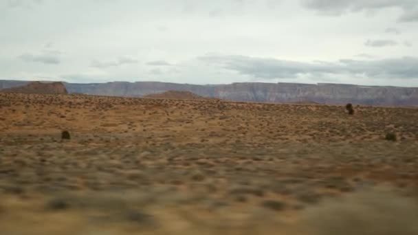 Road trip to Grand Canyon, Arizona USA, driving auto from Utah. Route 89. Hitchhiking traveling in America, local journey, wild west calm atmosphere of indian lands. Colorado plateau from car window — Stock Video